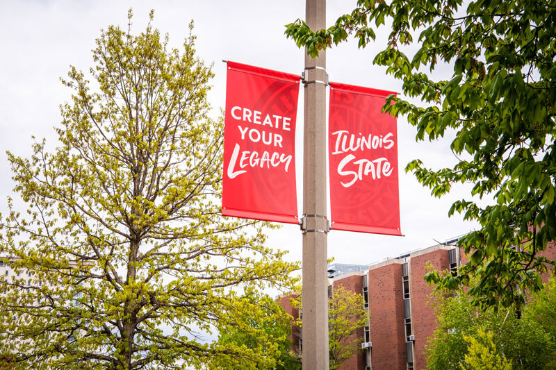 Banners on a light pole read: Create Your Legacy; Illinois State